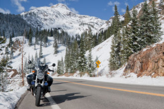 parked motorcycle in front of snowy mountains