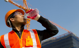 Construction worker staying safe and hydrated for summer
