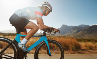 Female cyclist riding her bicycle on a hot summer day