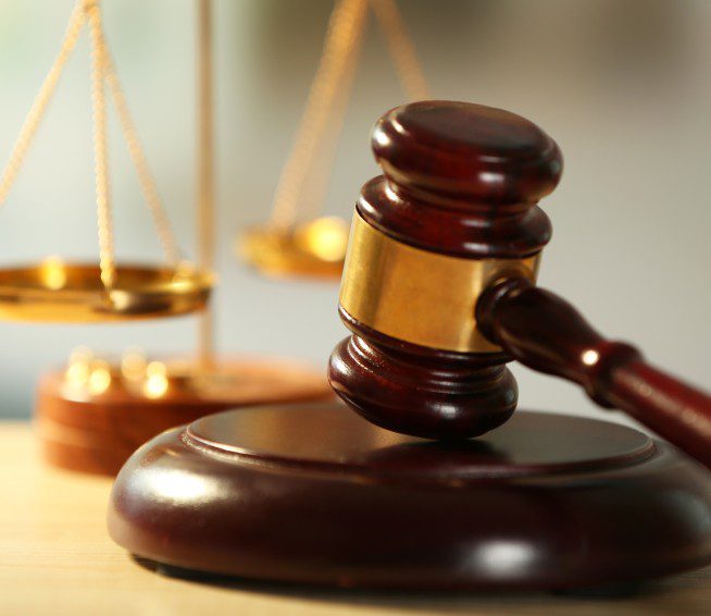 a gavel sits in front of scales