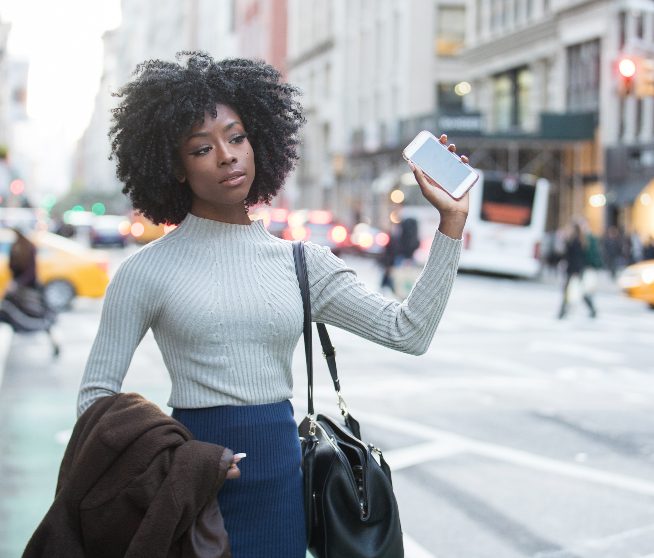 a woman hails a car