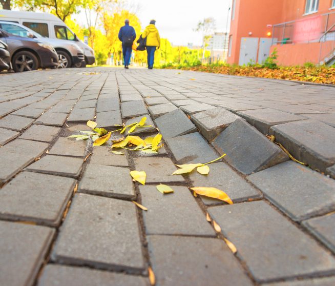 an uneven patch of bricks in the road