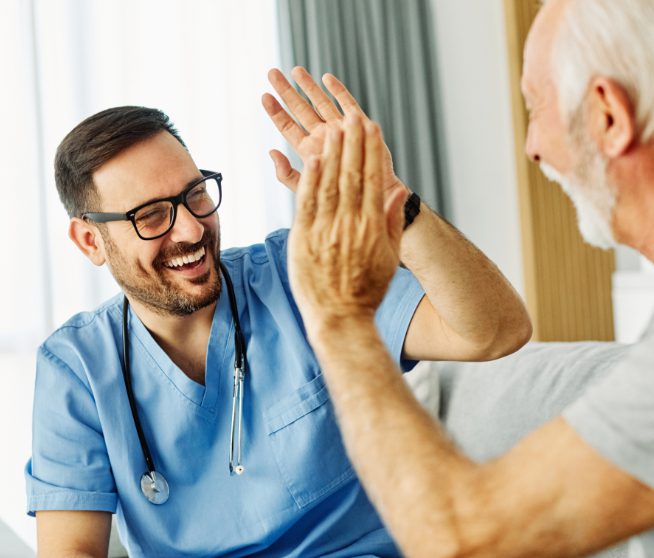 Nursing home staff greeting a facility elderly patient.