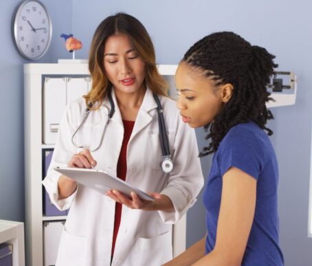 Nurse speaking with a client who suspects that their elderly loved one has been neglected and abused in a nursing home.