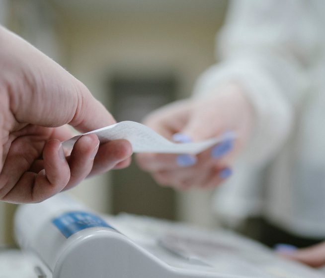 a man hands a woman a receipt