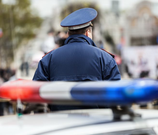 a cop faces away from the camera