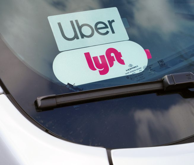 a car windshield with an uber and lyft sticker