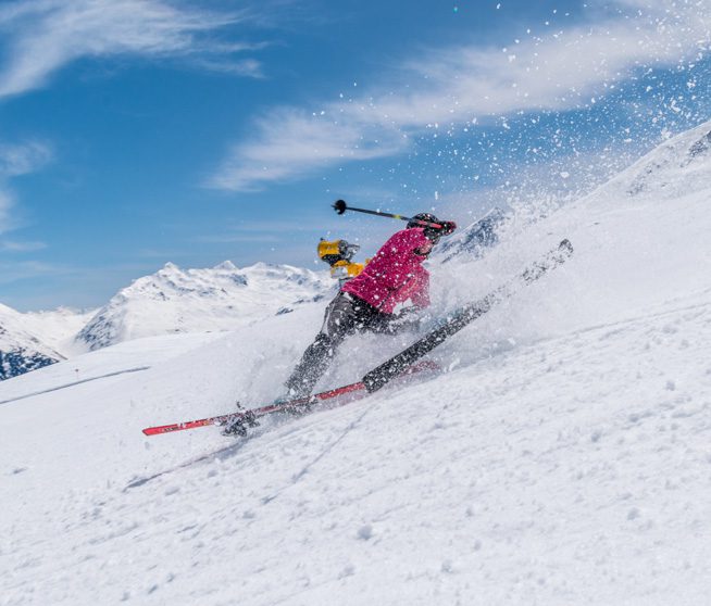 a woman skis down a mountain