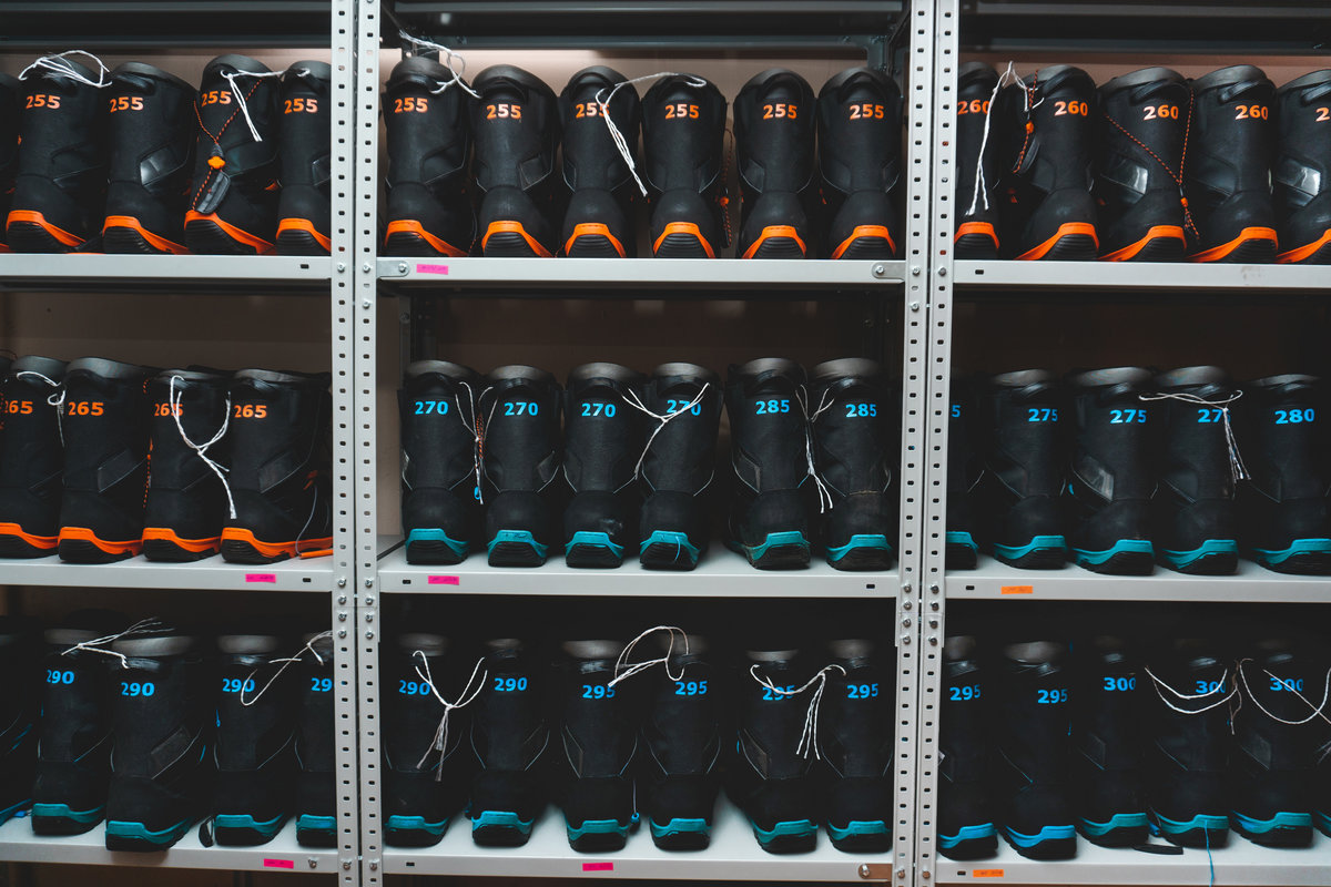 snowboard and ski boots on the shelf in the store, ski equipment