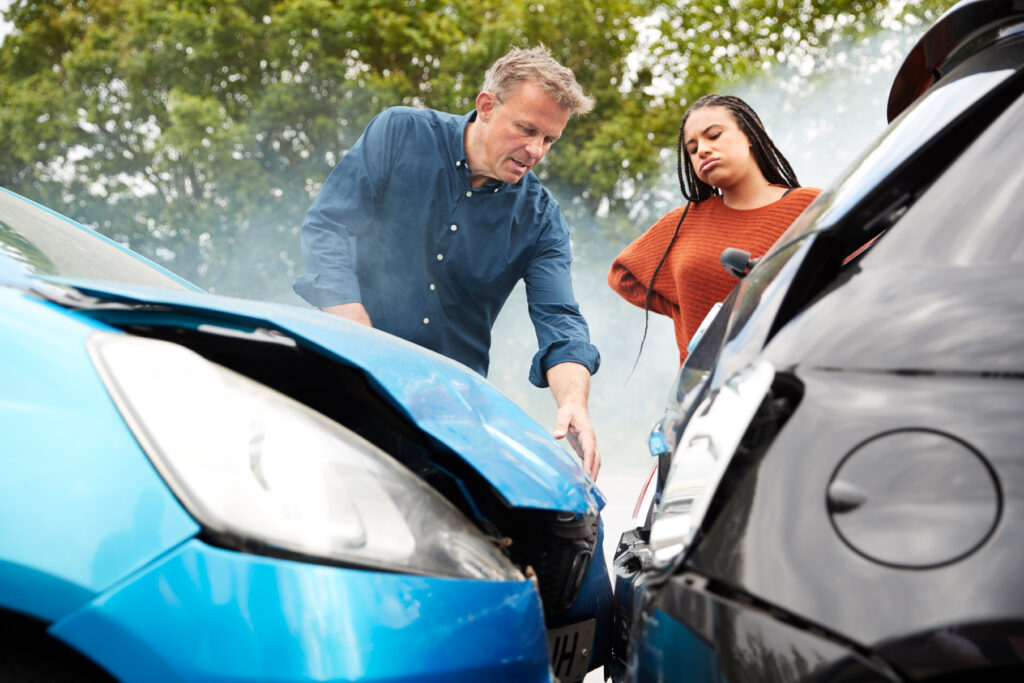 Teenager receiving car keys from a parent in a driveway