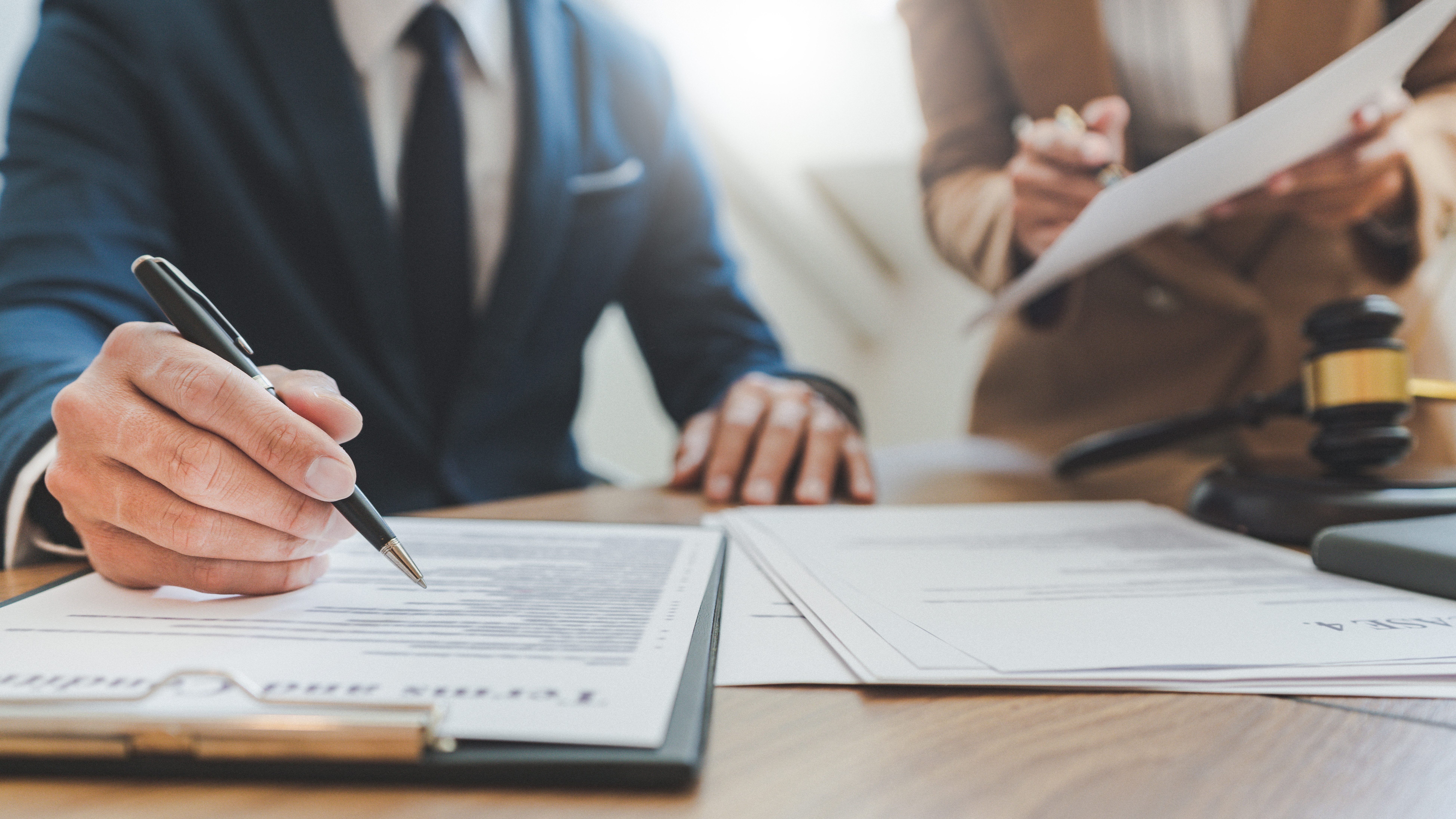 Attorney reviewing a personal injury demand letter and case documents at a law office desk