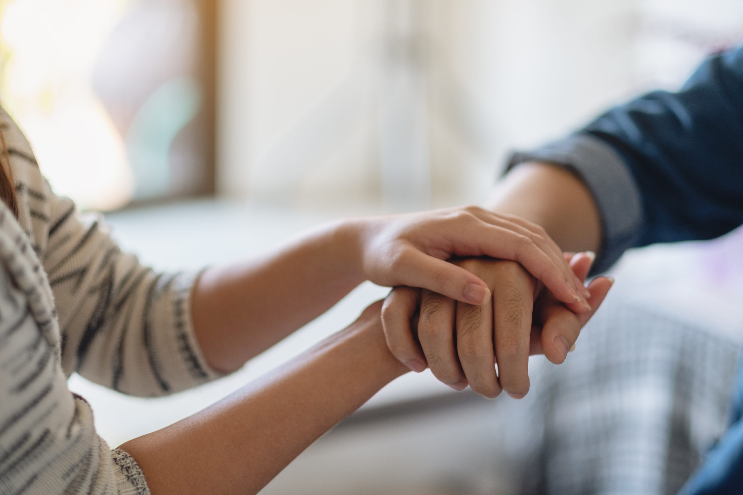 Couple holding hands in a moment of support and comfort Couple holding hands in a moment of support and comfort