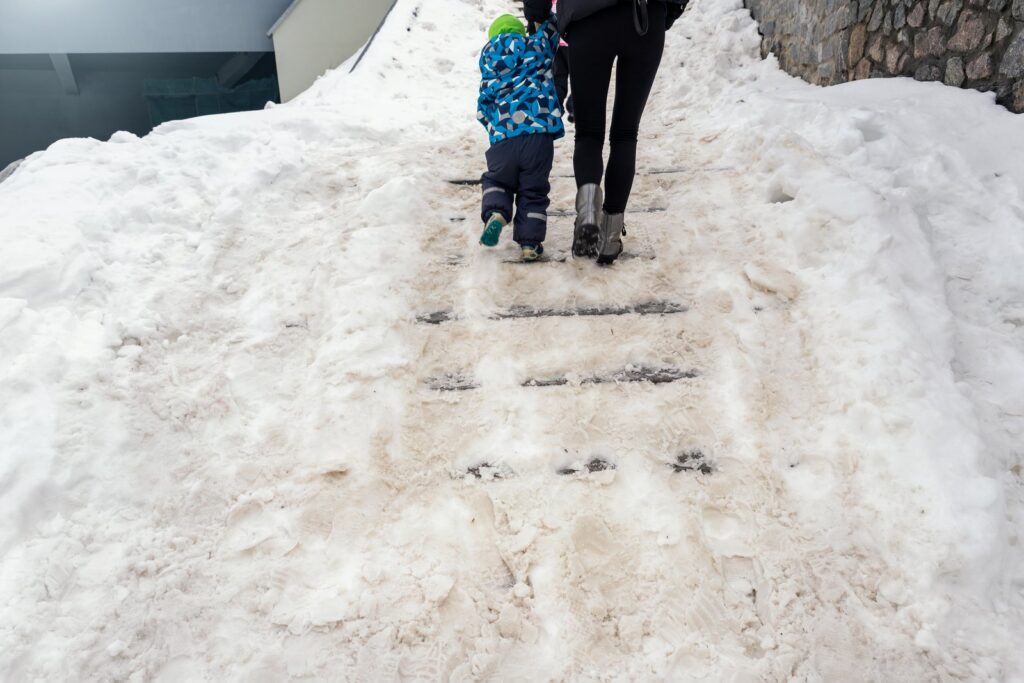 Icy snow-covered sidewalk hazard outside a Colorado home